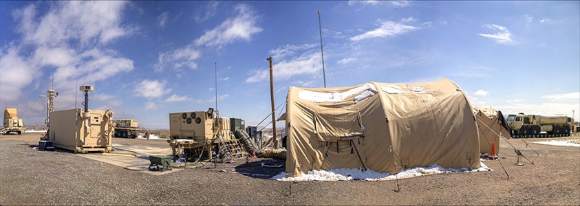 military tents with equipment set up in desert