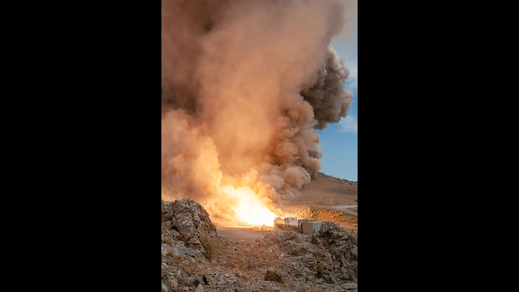 rocket test in desert with smoke in the sky