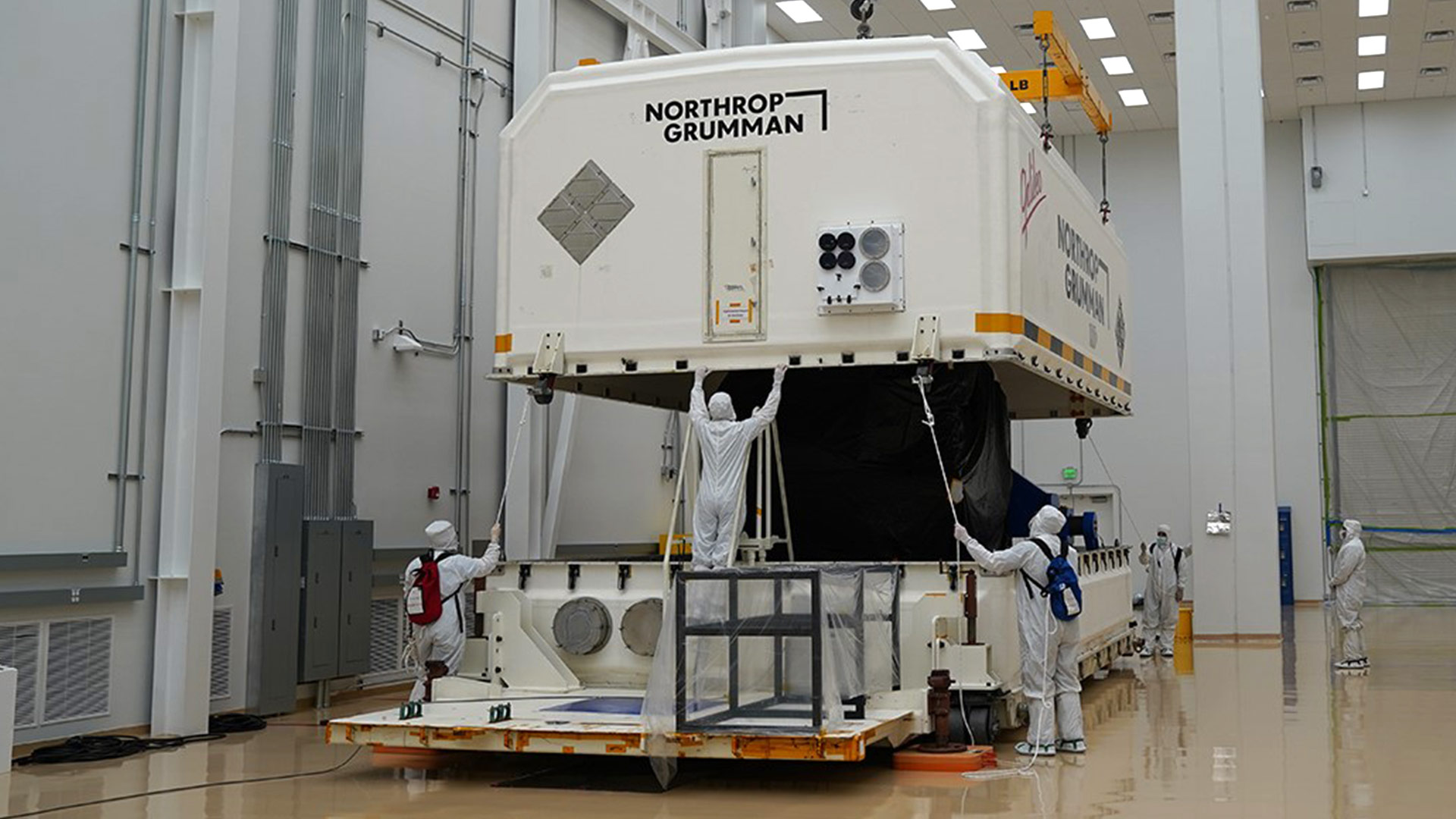 workers packaging spacecraft