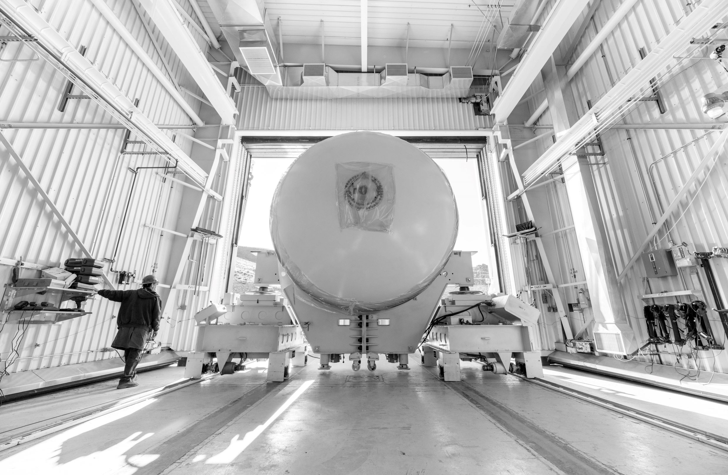 A forward segment of an SLS booster moves into the test bay.