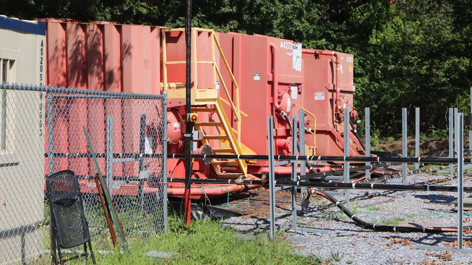 red storage trailers on gravel bed
